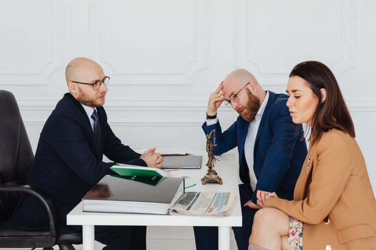 Lawyer consulting couple on divorce settlement in an office setting