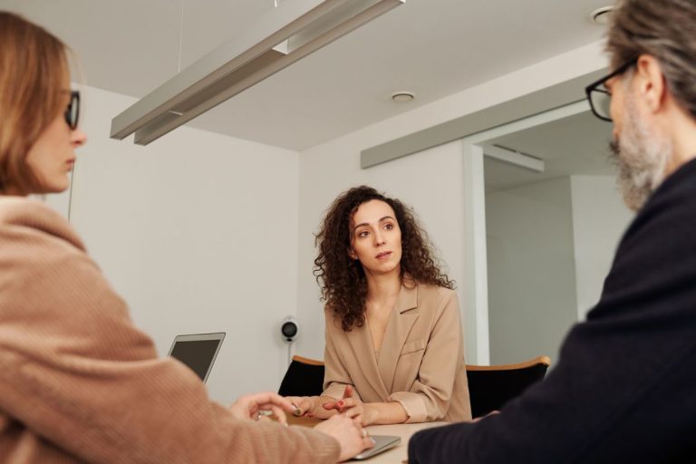 Law Society Joins Three Groups to Launch Solicitor Wellbeing Alliance 1 Three colleagues seated around a table in a workplace discussion